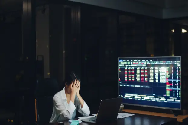 A woman stressed about trading.